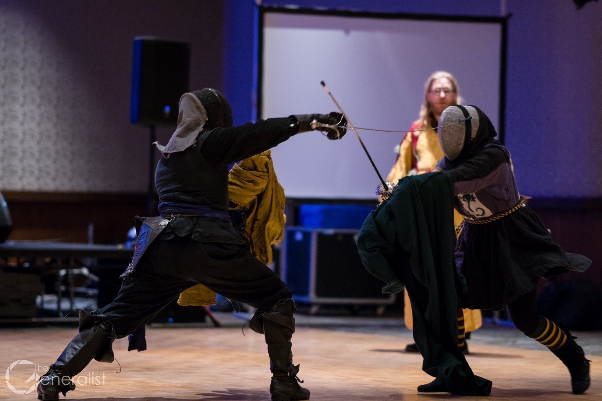 Two SCA rapier fencers fighting with rapier & cloak.