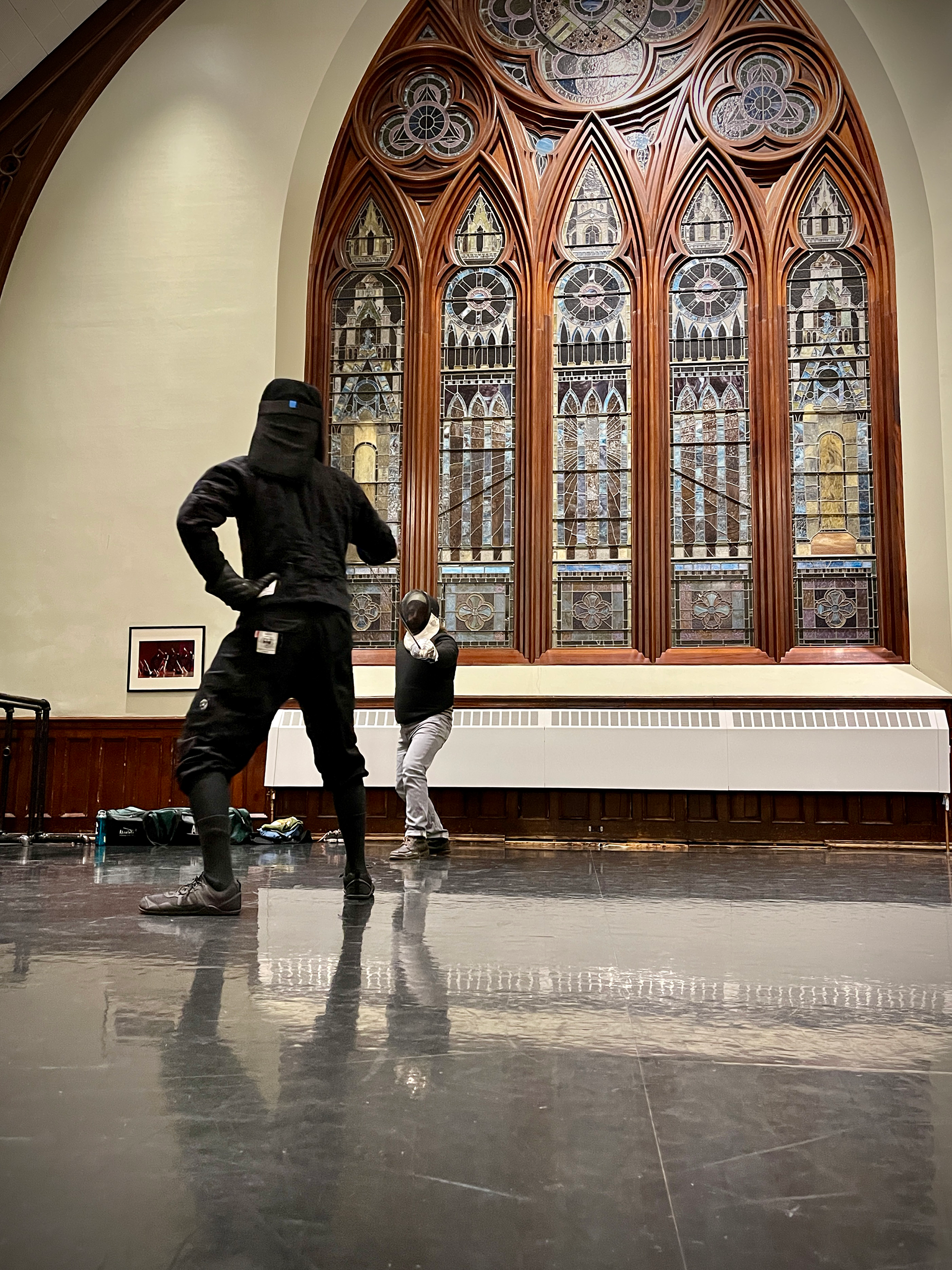 Two Boston HEMA fencers sparring with Italian dueling sabers at the Boston Academie d'Armes sparring night at Old Cambridge Baptist Church.