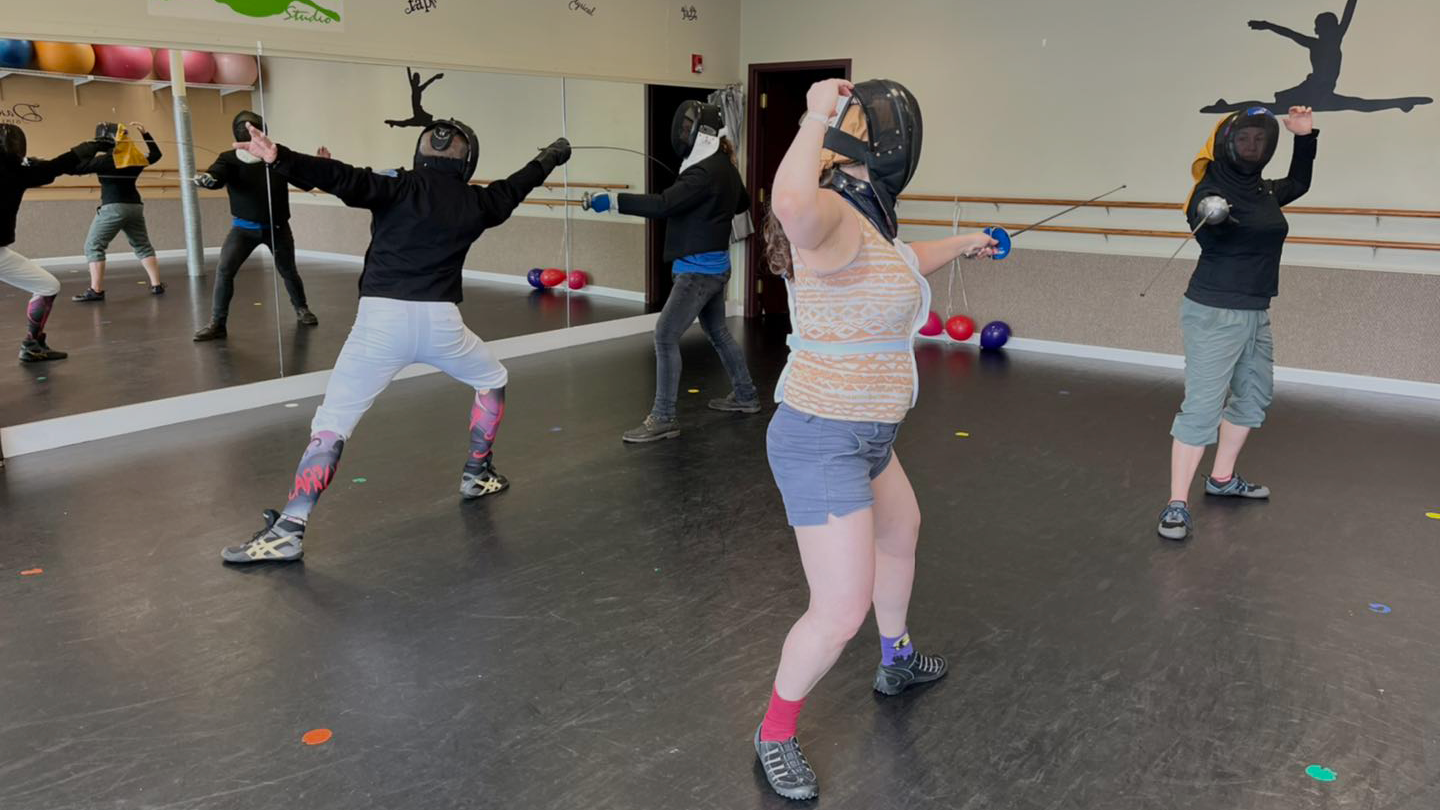 Group of classical fencers working on their straight thrusts from invitations with the Italian foil or dueling sword.