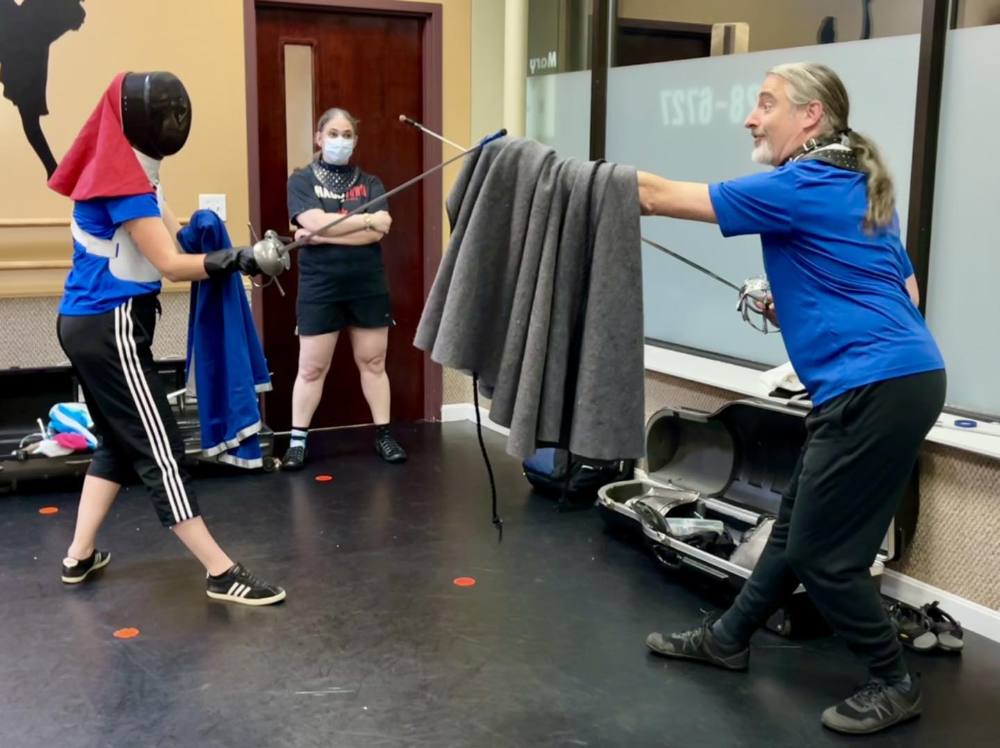 Boston HEMA class with an instructor teaching basic Fabris rapier and cloak guards.