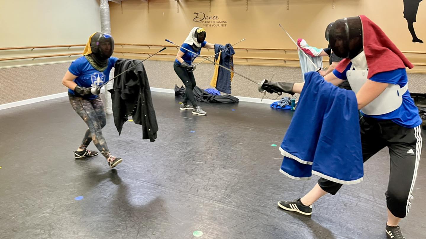 Two woman historical fencers train with cloak and rapier in Somerville MA