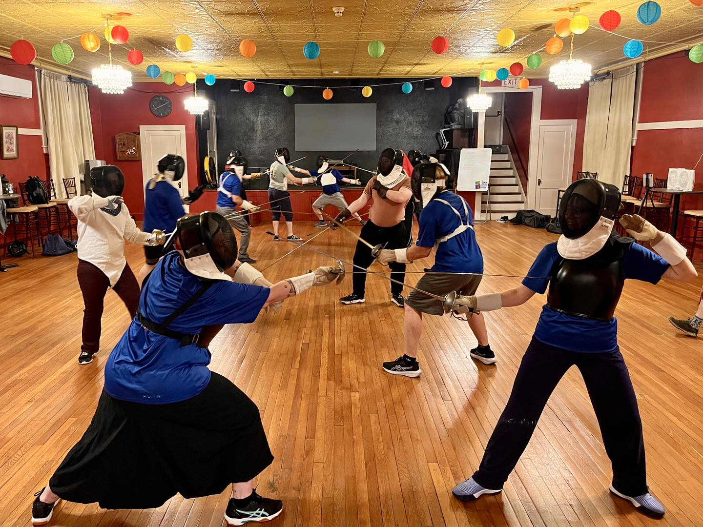 Group of rapier fencers in Boston practicing offhand work