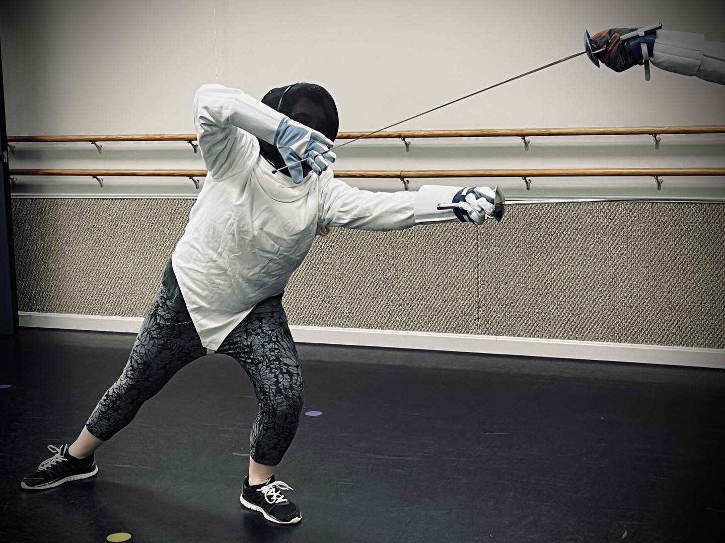 Rose with Italian dueling sword showing a closed guard, lunging