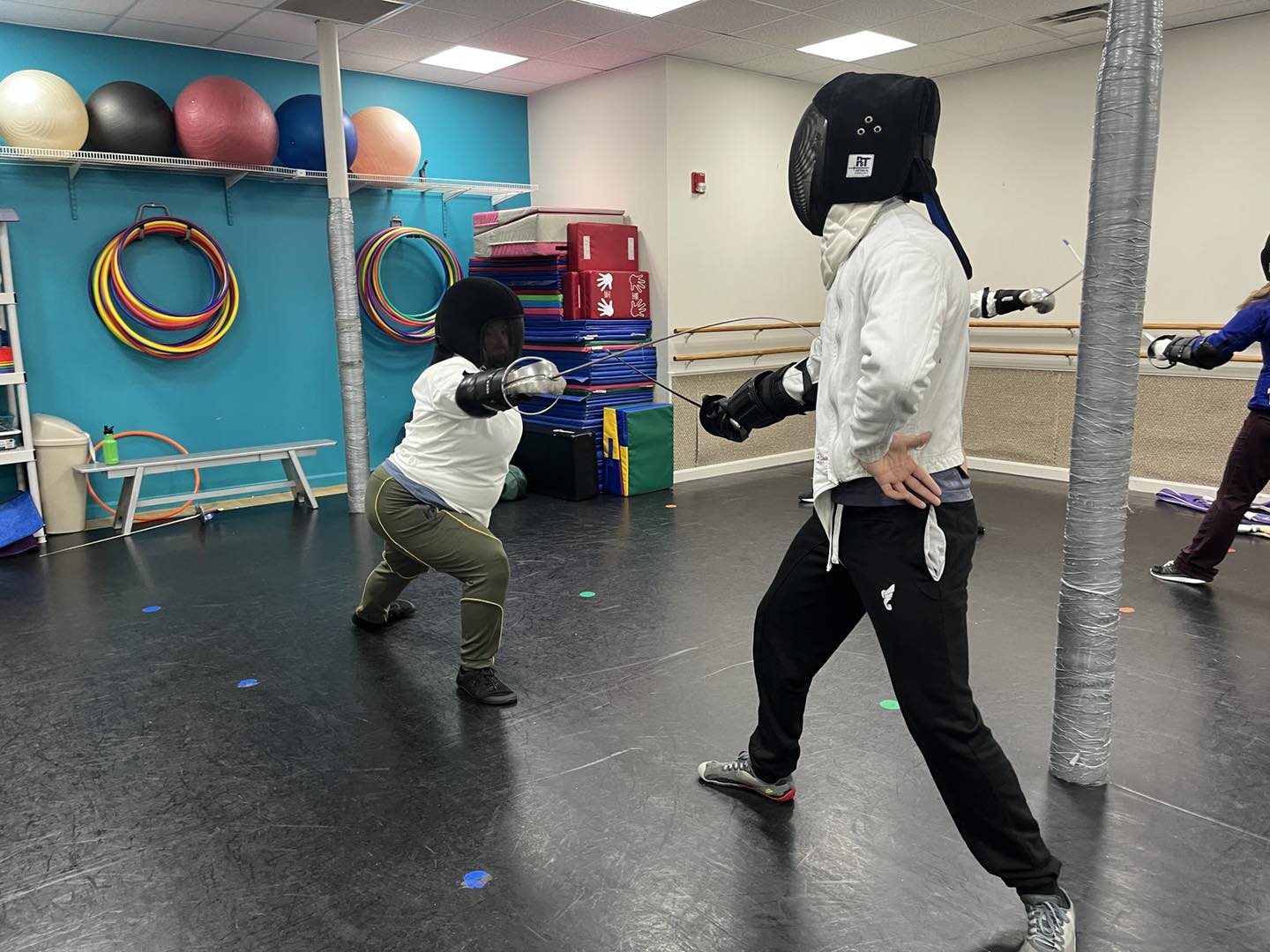 A thrust with Italian dueling saber at a classical fencing class in Somerville MA