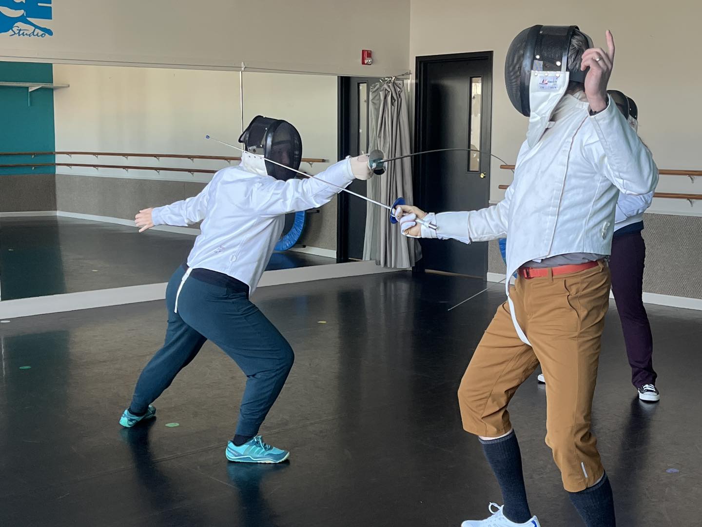 Boston classical fencer lunging with a straight thrust in 3rd